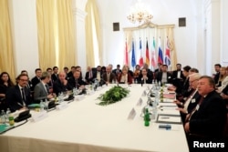 FILE - Iran's top nuclear negotiator Abbas Araqchi and Secretary General of the European External Action Service (EEAS) Helga Schmid attend a meeting of the JCPOA Joint Commission in Vienna, Austria, June 28, 2019.