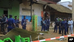FILE - An area is cordoned off as police inspect the scene of a bomb explosion in Beni, DRC, Dec. 26, 2021. Islamic State claimed responsibility for the bombing, which officials blamed on the Allied Democratic Forces.