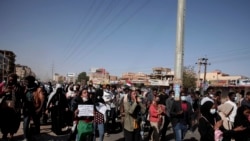 People chant slogans during a demonstration against the killing of dozens by Sudanese security forces since the Oct. 25, 2021 military takeover, in Khartoum, Sudan, Jan. 20, 2022.