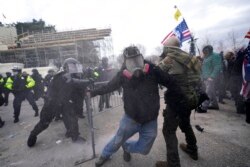 Trump supporters try to break through a police barrier at the Capitol in Washington, Jan. 6, 2021.
