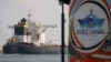 FILE - A cargo ship sails past the town of Ismailia, Egypt, March 30, 2021.