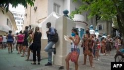 People wait in line to be tested for COVID-19 outside the Manoel Jose Ferreira public health care unit in Rio de Janiero, Brazil, Jan. 5, 2022. 