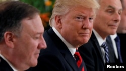 U.S. President Donald Trump flanked by Secretary of State Mike Pompeo and White House Chief of Staff John Kelly attend a lunch with Singapore's Prime Minister Lee Hsien Loong and officials at the Istana in Singapore, June 11, 2018. 