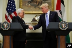 President Donald Trump shakes hands with Palestinian leader Mahmoud Abbas after their statements in the Roosevelt Room of the White House in Washington, May 3, 2017.