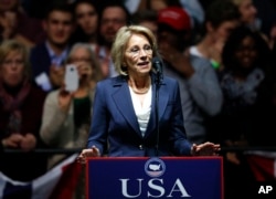 FILE - Betsy DeVos, selected for Education Secretary by President-elect Donald Trump speaks during a rally, in Grand Rapids, Michigan, Dec. 9, 2016.