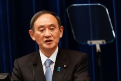 FILE - Japan's Prime Minister Yoshihide Suga speaks during a press conference in Tokyo, March 18, 2021.