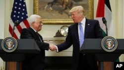 FILE - President Donald Trump shakes hands with Palestinian leader Mahmoud Abbas after their statements in the Roosevelt Room of the White House in Washington, May 3, 2017.
