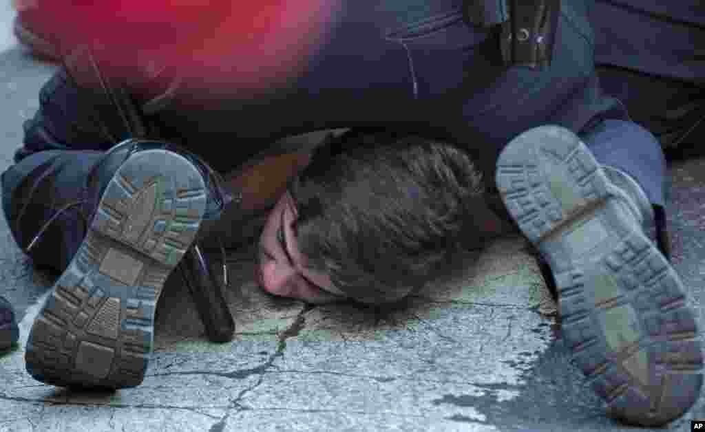 A person is arrested by police officers while protesting the death of Freddie Gray, a Baltimore man who died while in police custody near Union Square, in New York,&nbsp; April 29, 2015.