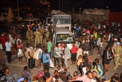 U.N. peacekeepers stand guard as civilians watch smoke and flames following volcanic activity at Mount Nyiragongo near Goma, in the Democratic Republic of the Congo, May 22, 2021.