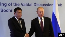 Russian President Vladimir Putin (R) shakes hands with Philippine's President Rodrigo Duterte prior to their meeting at the Valdai Discussion Club in Sochi, Russia, Oct. 3, 2019.