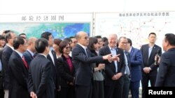 FILE - Taiwan's Kaohsiung Mayor Han Kuo-yu, center, visits the Xiamen International Cruise Center in Fujian province, China, March 26, 2019. 