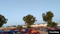 After the detention center was bombed, remaining structures appeared unstable and five days later, migrants were still sleeping outdoors. Pictured and transmitted to VOA July 7, 2019, in Tripoli, Libya. 