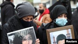 Supporters of victims of the Beirut port explosion react during a protest, after a Lebanese court removed the judge leading the investigation into the explosion, outside the Justice Palace in Beirut, Lebanon, Feb. 19, 2021. 