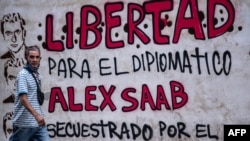 FILE - A man walks past graffiti reading, "Freedom for diplomat Alex Saab, kidnapped by the government of Cape Verde," in Caracas, Venezuela, Feb. 23, 2021. A Cape Verde court on Aug. 30 upheld a decision to extradite Saab to the U.S.