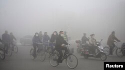 A worker installs the names of the victims of the 2004 Indian Ocean tsunami on the wall of the Tsunami Museum ahead of the 10th anniversary of the killer waves in Banda Aceh, Aceh province, Indonesia.