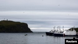 FILE - Russian coast guard ships are moored at the southern Kurile Island of Shikotan, Sept. 14, 2015. Moscow says it will deploy new defense systems and drones to the disputed islands this year.
