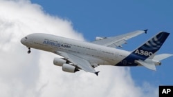 Migrants swim next to their overturned wooden boat during a rescue operation by Spanish NGO Open Arms south of the Italian island of Lampedusa in the Mediterranean Sea.
