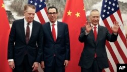 FILE - Chinese Vice Premier Liu He, right, gestures as U.S. Treasury Secretary Steven Mnuchin, center, chats with his Trade Representative Robert Lighthizer before their meeting in Beijing, May 1, 2019.