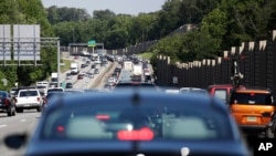 FILE - Traffic backs up on Interstate 20 at the beginning of the Memorial Day weekend in Lithonia, Ga., May 26, 2017. As the summer driving season begins, President Trump's tariffs on Mexico could raise gas prices.