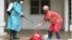 A Liberian Red Cross employee disinfects after removing a body suspected of having Ebola, Monrovia, September 2014. (Credit: International Alert)