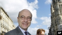 France's mayor of Bordeaux Alain Juppe arrives for a news conference as he was appointed France's foreign minister, February 28, 2011