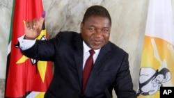 FILE - Mozambican President Felipe Nyusi poses at a polling station where he cast his vote in Maputo, Oct. 15, 2019. 
