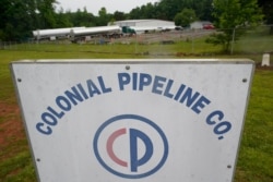 Tanker trucks are parked near the entrance of Colonial Pipeline Company, May 12, 2021, in Charlotte, N.C.