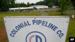 Tanker trucks are parked near the entrance of Colonial Pipeline Company, May 12, 2021, in Charlotte, N.C. 