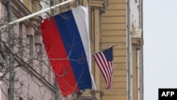 A Russian flag flies next to a U.S. flag at the U.S. Embassy in Moscow on March 13, 2025. U.S. special envoy Steve Witkoff arrived in Moscow Thursday to meet with Russian officials about a Ukraine-Russia ceasefire proposal.