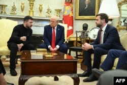 Ukrainian President Volodymyr Zelenskyy speaks to U.S. Vice President JD Vance as they meet with President Donald Trump in the Oval Office of the White House in Washington, Feb. 28, 2025.