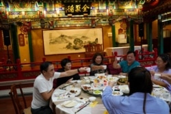 People dine at the Quanjude Peking roast duck restaurant, following the coronavirus disease (COVID-19) outbreak, in Beijing, Aug. 18, 2020.