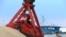 FILE - Imported soybeans are transported at a port in Nantong, Jiangsu province, China, Aug. 6, 2018. 