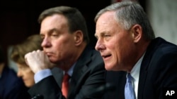 Senate Intelligence Committee chairman Sen. Richard Burr, R-NC, right, speaks next to Vice Chairman Sen. Mark Warner, D-VA., during a Senate Intelligence Committee hearing on Russian election activity and technology, Nov. 1, 2017, on Capitol Hill in Washington.