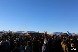 Water protectors celebrate the decision of the Army Corps to deny the building of the Dakota Access Oil Pipeline through their and sacred Sioux land (E. Sarai/VOA)