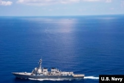 FILE - USS Lassen (DDG 82) operates in international waters near the Chinese People's Liberation Army (Navy) Jianghu V-class frigate Dongguan (560) while on patrol in U.S. 7th Fleet at South China Sea, Sep 29, 2015.