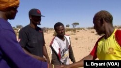 Tahir Abdoulaye (R) from Somalia is uncertain about his future.