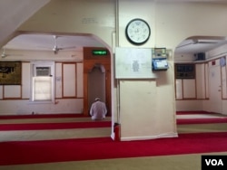 A lone worshipper prays at Al-Furqan Jame Mosque, in New York’s Ozone Park neighborhood.