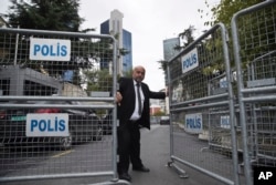FILE - A guard secures the entrance of the Saudi Arabia's Consulate in Istanbul, Oct. 17, 2018.