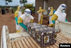 FILE - Healthcare workers carry the coffin of a baby believed to have died of Ebola, in Beni, North Kivu Province of Democratic Republic of Congo, Dec. 15, 2018.