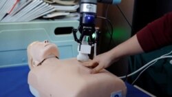 This photo shows a robot designed to help medical workers treat coronavirus patients remotely is pictured during a demonstration for the media at the aerospace engineering school of Tsinghua University in Beijing, China March 4, 2020. (REUTERS/Carlos Garc