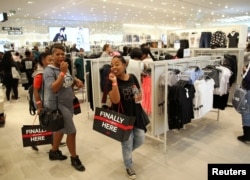 Shoppers react during the opening of the Mall of Africa in Midrand, outside Johannesburg, South Africa, April 28, 2016.