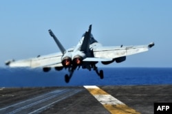 At Sea -- An F/A-18F Super Hornet takes-off from the US navy's super carrier USS Dwight D. Eisenhower (CVN-69) ("Ike") in the Mediterranean Sea, July 6, 2016