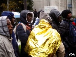 A group of migrants from Sudan wait for transportation in temporary shelters in Paris, November 2016. (L. Bryant/VOA)