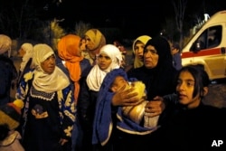 FILE - People wait to leave the besieged town of Madaya, northwest of Damascus, Syria, Jan. 11, 2016. The U.N. humanitarian chief has said about 400 people needed to be evacuated immediately to receive life-saving treatment for medical conditions, malnourishment and starvation.