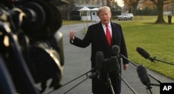 President Donald Trump speaks to reporters on the South Lawn of the White House in Washington, Dec. 4, 2017, before heading to Utah.