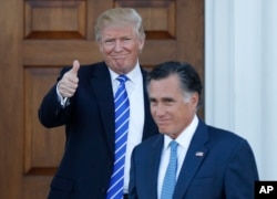 FILE - President-elect Donald Trump gives the thumbs-up as Mitt Romney leaves Trump National Golf Club Bedminster in Bedminster, N.J., Nov. 19, 2016.