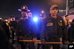 Authorities form a line to prevent protesters from entering an expressway in Chicago, Nov. 24, 2015. Officer Jason Van Dyke, who is white, shot Laquan McDonald, who is black, 16 times last year and was charged with first-degree murder Tuesday.