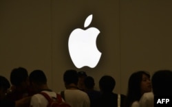 FILE - Customers line up at an Apple store in Taipei, Taiwan, July 1, 2017. Apple is among multinationals pressured by Beijing to recognize Taiwan as part of China.