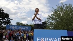 U.S. President Barack Obama reacts to supporters during a campaign event in Rochester, New Hampshire, August 18, 2012.