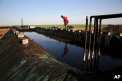 A former farmer works at a primitive refinery making crude oil into diesel and other products in a village in Rmeilan, Hassakeh province, Syria, April 6, 2018.